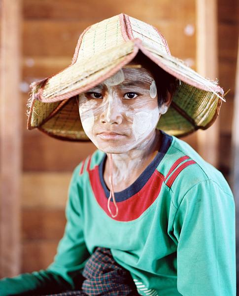 Napo, a 13 year old boy poses for a portrait at a cheroot cigar factory on Inle Lake. Many of the cigars have anise, in addition to tobacco mixed in.