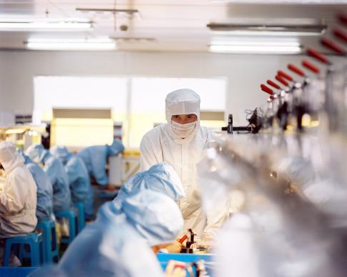 Barrett Comiskey in the clean room of a Shanghai factory that manufactures E Ink displays. E Ink is a display technology that Barrett invented while an undergraduate student at MIT, and is used in the Amazon Kindle, an electronic reading device.