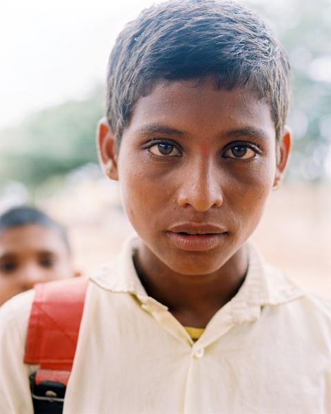 A school-age Indian boy near the city of Aihole in Karnataka Province, India.