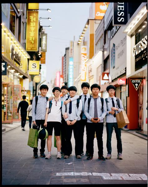 Chungjangno District, a shopping and dense urban area in Gwangju, South Korea.

Here a group of teenage Korean boys in school uniforms pause for a photo on one of the main pedestrian roads.

(Source: Wikipedia):

Gwangju (Korean pronunciation: [kwaŋdʑu]) is the sixth largest city in South Korea. It is a designated metropolitan city under the direct control of the central government's Home Minister. The city was also the capital of South Jeolla Province until the provincial office moved to the southern village of Namak inMuan County in 2005.

Gwang (광, hanja 光) means 
