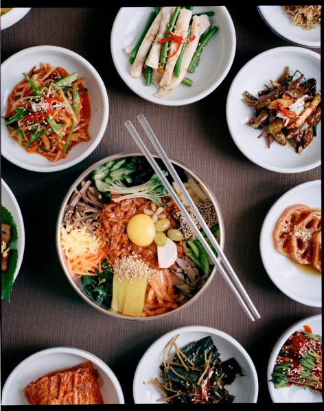Gajok Hwegwan, a well-known bibimbap restaurant, located in the birthplace of Bibimbap, Jeonju.

Pictured here is bibimbap along with several side dishes. Bibimbap literally means 'mixed rice' and is normally served hot in a bowl of warm rice, seasoned vegetables, gochujang, doenjang, and a raw egg.

Some of the side dishes pictured here include:

-side dishes ( see numbered picture attached)
 1 kongnamulguk - bean sprouts soup
 2 mumalaengi - seasoned dried radish
 3 dureup - edible shoots of fatsia
 4 danguinamul - Seasoned angelica gigas 
 5 Kimchi 
 6 Chwinamul (wikipedia) http://en.wikipedia.org/wiki/Chwinamul
 7 Arongjatae Gimjangachi - Gajokhwaegwan made dish (seasoned dried laver with soy sauce )
 8 gamjajorim - seasoned boiled potato
 9 Dorajijeongwa - cooked roots of balloon flowers
 10 yeongeunjorim - seasoned lotus root
 11 gyeranjjim - boiled eggs
 12 supsanjeok - korean kebab
 13 munamul - seasoned daikon leaves
 14 hwangpomuk - yellow acorn jelly
 15 myeolchibokeum - Stir-Fried anchovies
 16 gochujjangachi - seasoned chilli 
 17 maneuljjong - seasoned garlic leaves
 18 kongnamuljapchae - seasoned sprouts with potato noodle
 19 Gulbijjangachi - Seasoned Dried yellow Corvina
 20 Pagimchi - scallion kimchi
 21 gochujorim - seasoned chill


(Source: Wikipedia)
Jeonju, written as 전주시 (Korean pronunciation: [tɕʌndʑu]) is a city in South Korea, and the capital of North Jeolla Province. It is an important tourist center famous for Korean food, historic buildings, sports activities and innovative festivals.

In May 2012, Jeonju was chosen as a Creative Cities for Gastronomy as part of UNESCO's Creative Cities Network. This honour recognize the city's traditional home cooking handed down through generations over thousands of years, its active public and private food research, a system of nurturing talented chefs, and its hosting of distinctive local food festivals

Jeonju bibimbap 전주비빔밥, a traditional local food, is well-known across South Ko