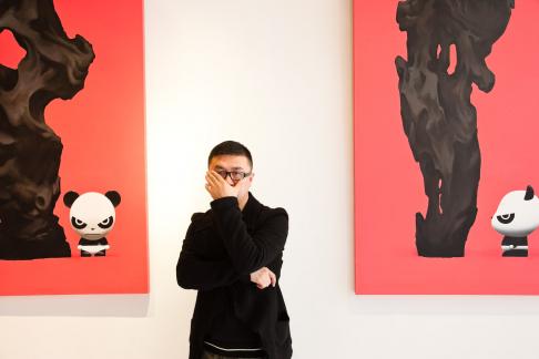 Renowned artist Jiji at his studio in Shanghai, China. Jiji is well-known for his depictions of angry pandas on canvas, sculptures, and through his clothing brand 'Hi Panda'. His t-shirts can be purchased online or through Shirt-Flag retailers in Shanghai, China.