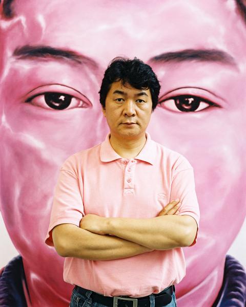 Tibetan contemporary artist Tsewang Tashi in front of his piece 