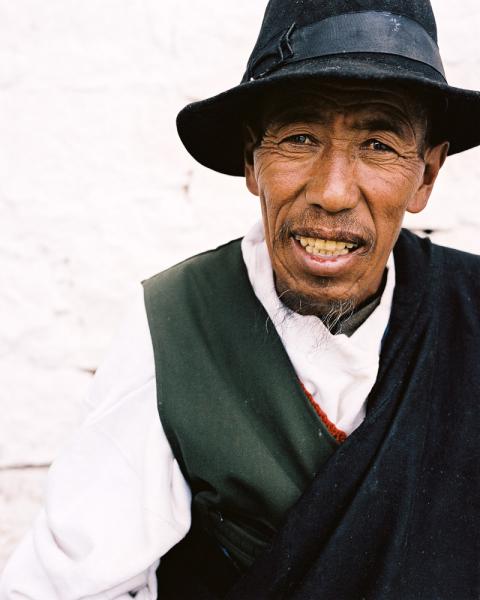 A portrait of a man outside the Potola Palace in Lhasa, Tibet, China.